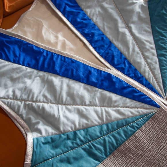 Gilet matelassé sans manches en patchwork bleu et blanc.